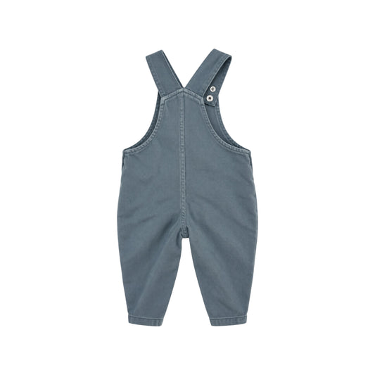 Back view of Arlo blue children's dungarees showing adjustable shoulder straps, central seam and tapered legs.