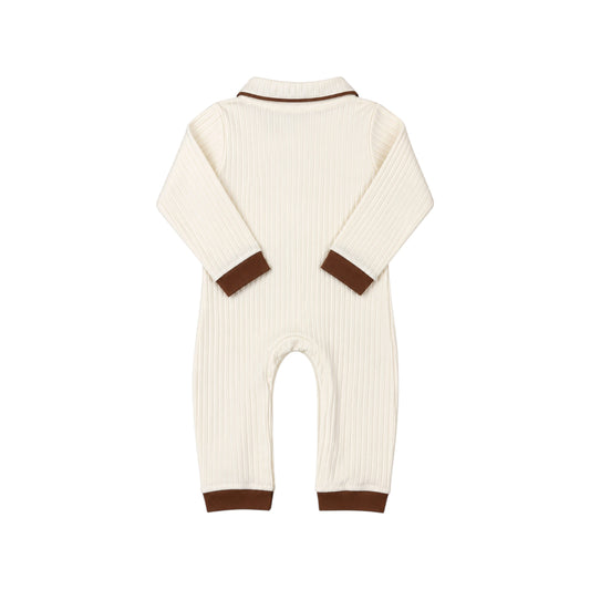 Back view of the Bobbi Romper by That’s Not Fair London, showing cream ribbed fabric, contrasting brown collar trim and matching brown cuffs.