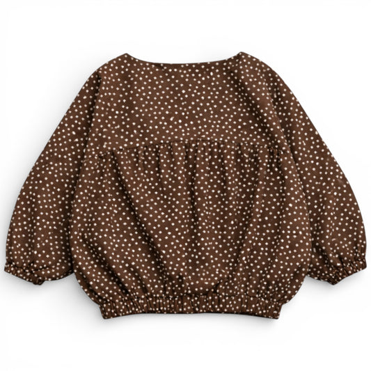 Back view of children’s chocolate brown printed cotton jacket showing rounded balloon shape and elasticated hem