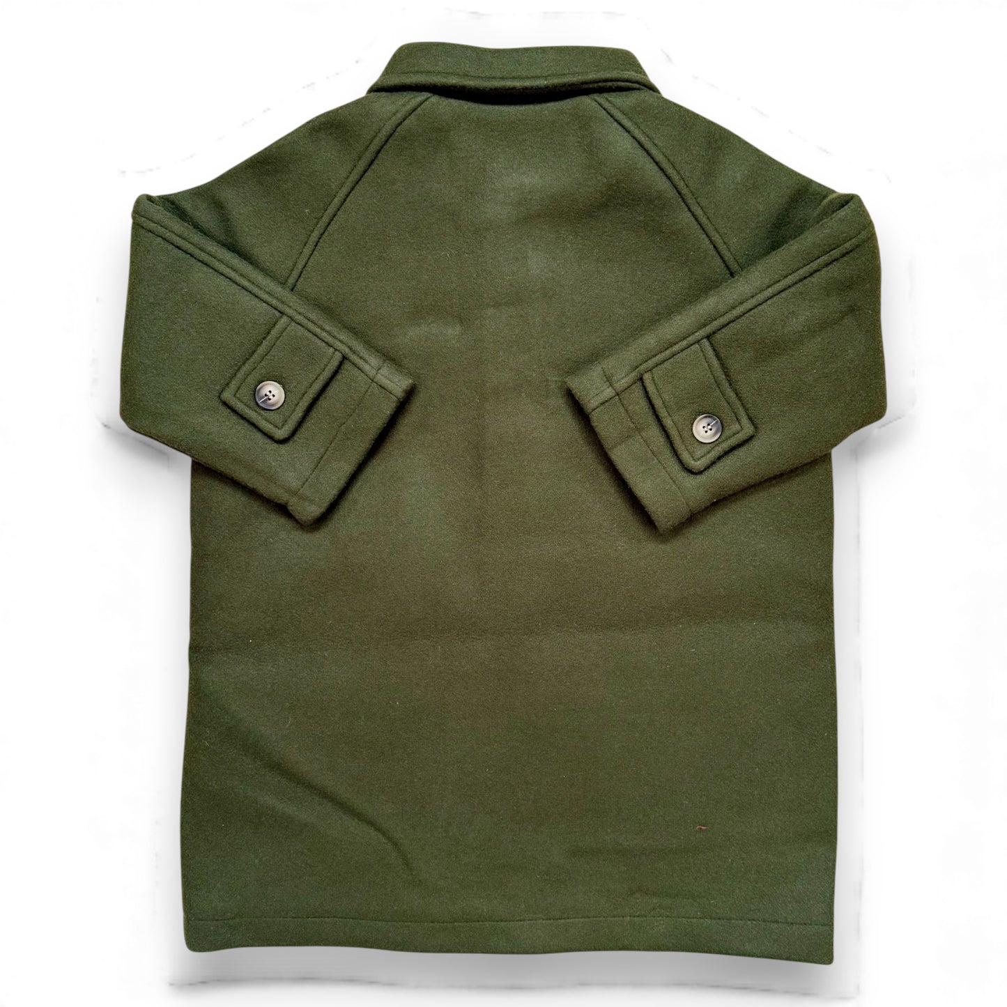 Olive boiled wool children’s pea coat with raglan sleeves, flap pockets, sleeve tabs and quilted lining.