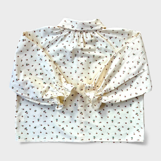 Brushed cotton children’s blouse with slim Peter Pan collar, button front, drop shoulders and frill cuff sleeves.