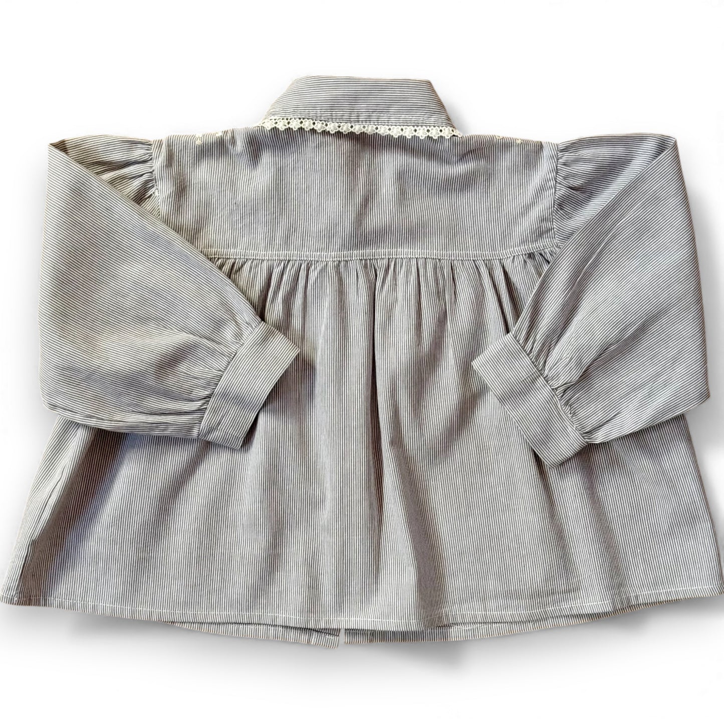 Back view of children’s pinstripe A-line blouse with deep gathered yoke and full sleeves