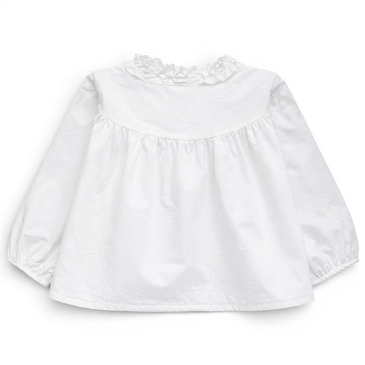 Back view of white trapeze cotton blouse with gathered yoke and ruched balloon sleeves, That’s Not Fair London