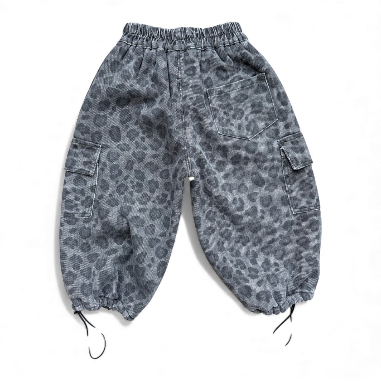 Grey animal-print children’s cargo pants with high elasticated waist, cargo pockets, patch back pocket and drawstring cuffs — back view.