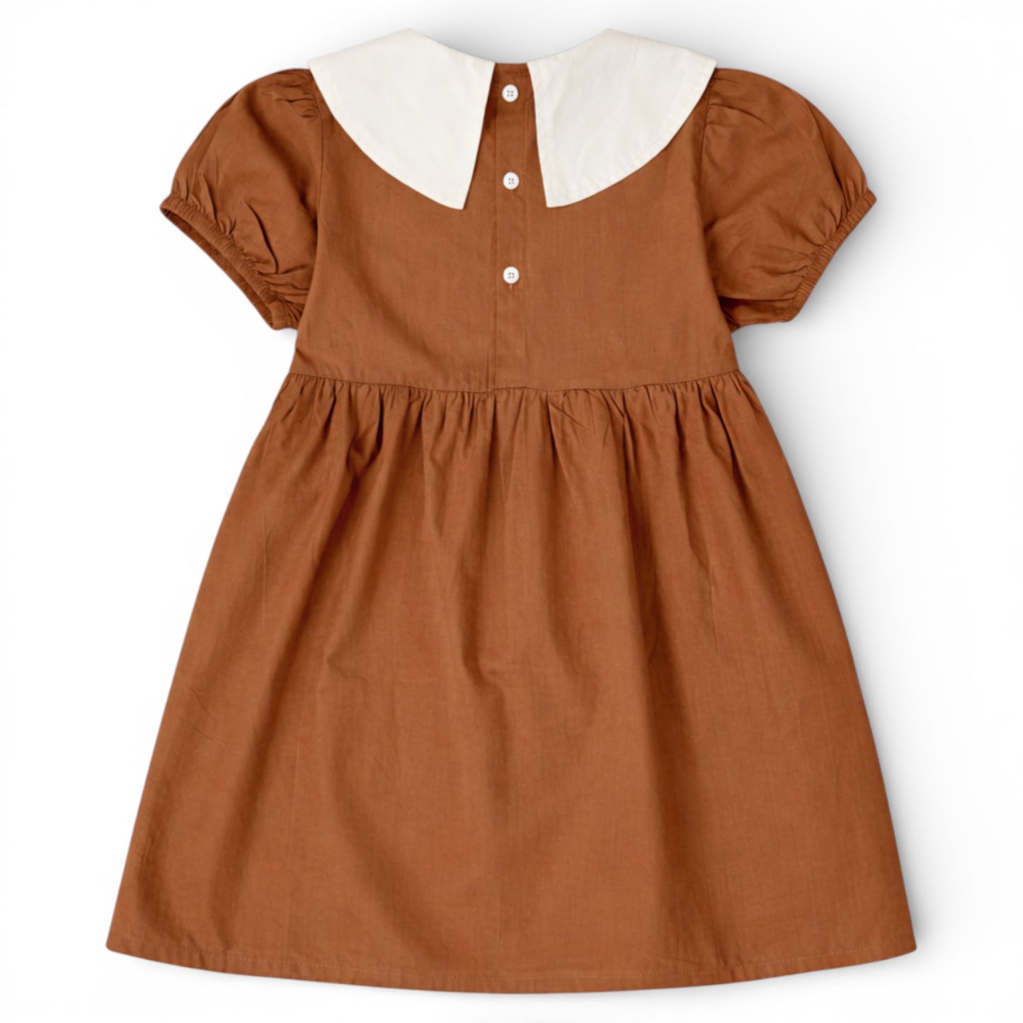 Back view of brown cotton empire line smock dress with Peter Pan collar