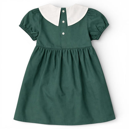 Back view of green cotton empire line smock dress with Peter Pan collar