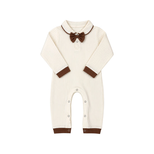 Bobbi Romper by That’s Not Fair London, cream ribbed long-sleeve baby romper with chocolate-brown collar trim, cuffs and matching bow tie.

