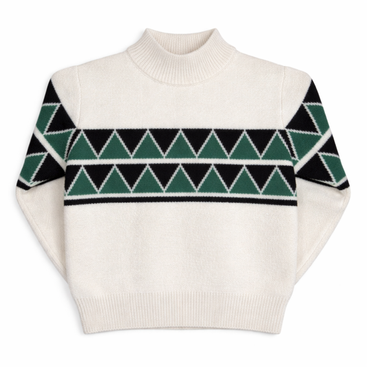 Children’s cream knit jumper with short turtle neck, drop shoulders, and green and black Fair Isle–inspired pattern across the chest.