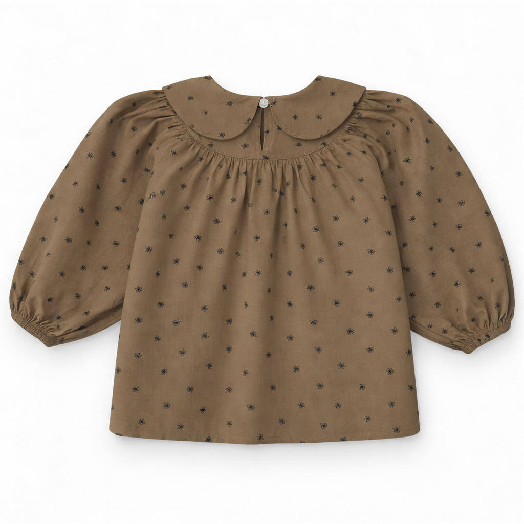 Back view of children’s blouse with keyhole opening and button loop fastening