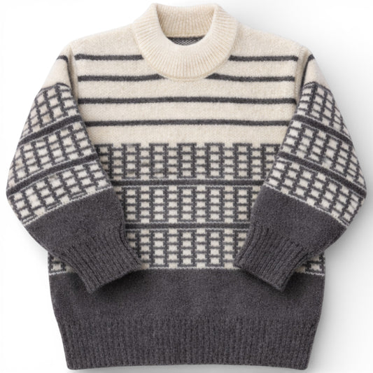 Children’s patterned knit jumper with drop shoulder and slight turtle neck.