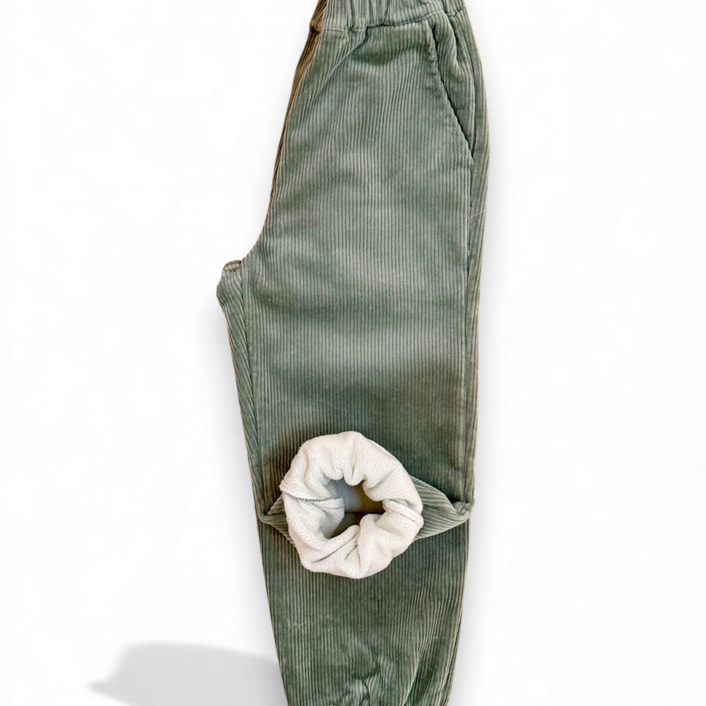 Close-up of green chunky corduroy fabric showing soft fleece lining and ribbed texture from That’s Not Fair London