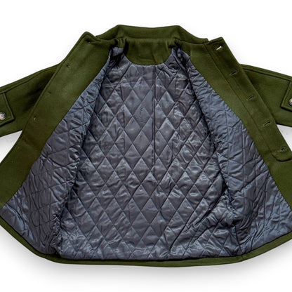 Olive boiled wool children’s pea coat with raglan sleeves, flap pockets, sleeve tabs and quilted lining.