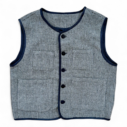 Children’s wool gilet in blue check with quilted cotton lining and patch pockets — front view.