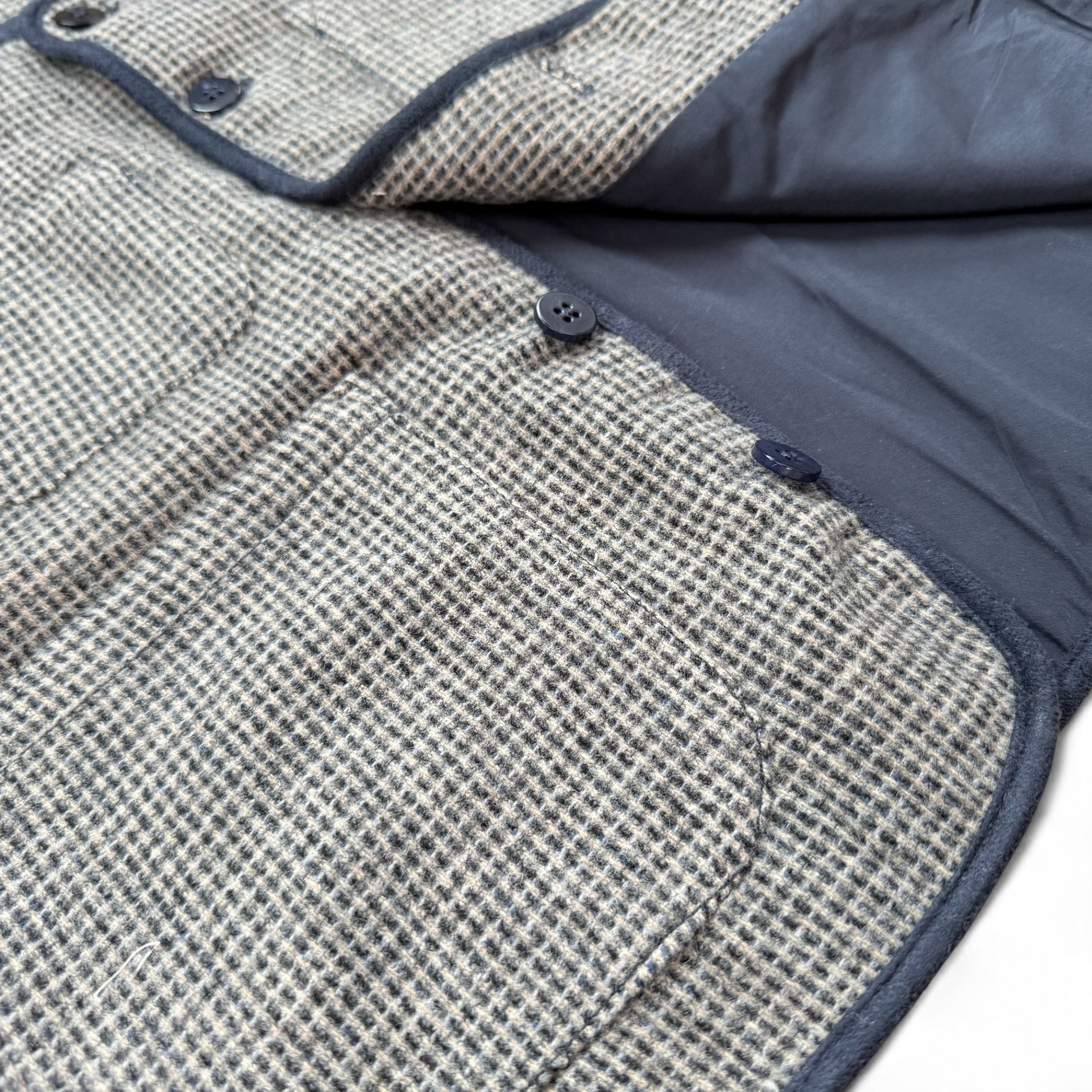 Children’s blue check wool gilet showing quilted cotton lining and patch pockets — open front view.