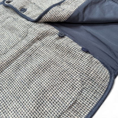 Children’s blue check wool gilet showing quilted cotton lining and patch pockets — open front view.