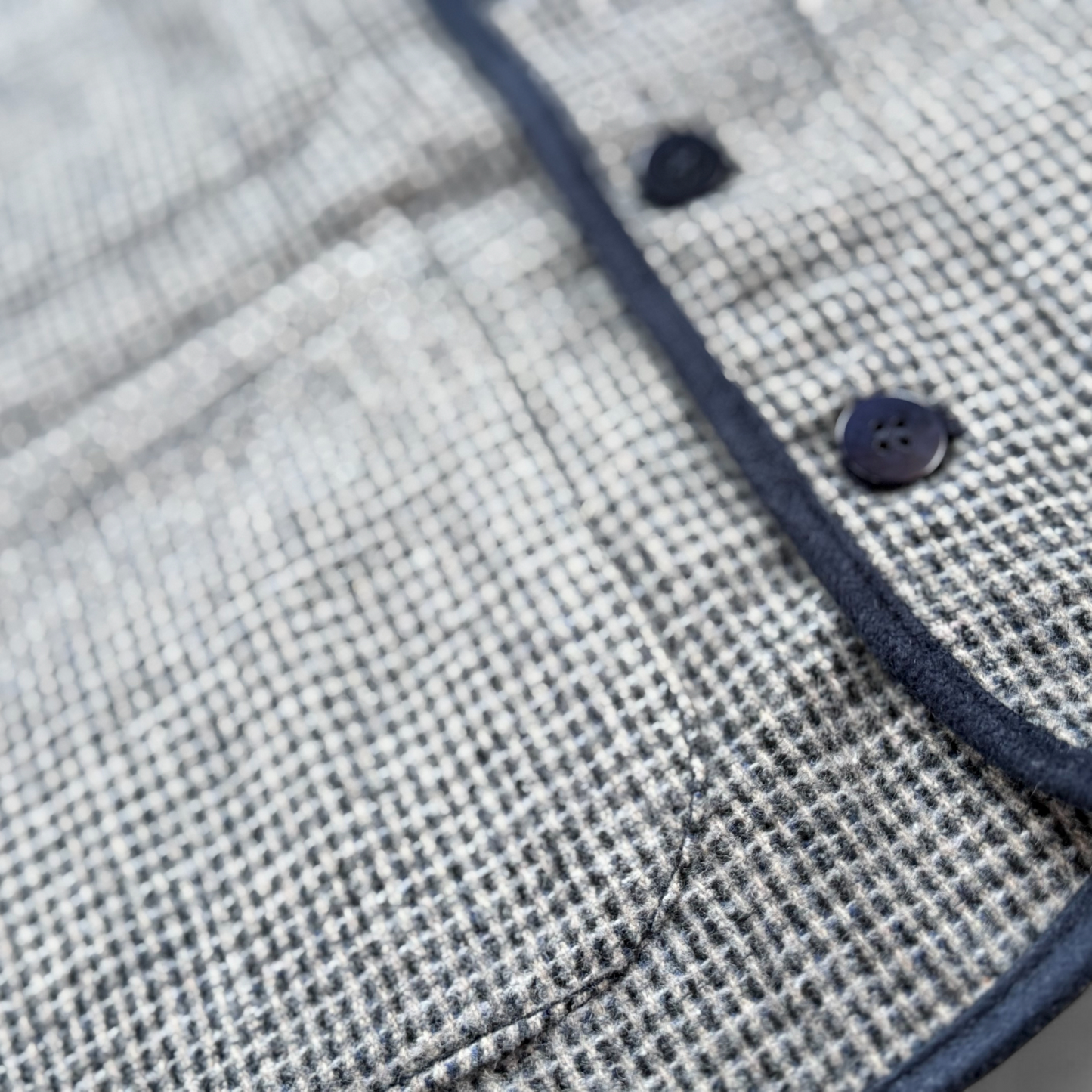 Children’s blue check wool gilet detail view.