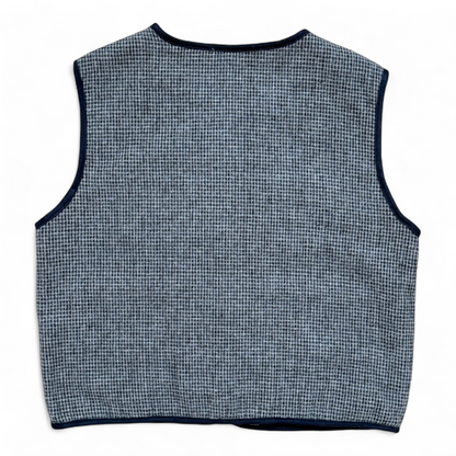 Children’s wool gilet in blue check with quilted cotton lining and patch pockets — back view.
