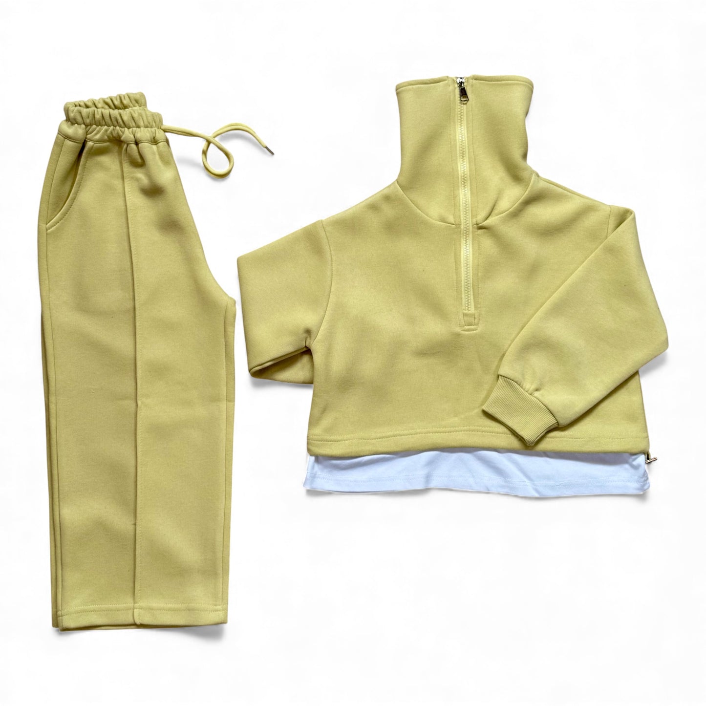 Sherbet-lemon organic cotton children’s tracksuit with funnel-neck top, mock T-shirt underlayer with drawstring, and straight-leg stitched-pleat trousers.
