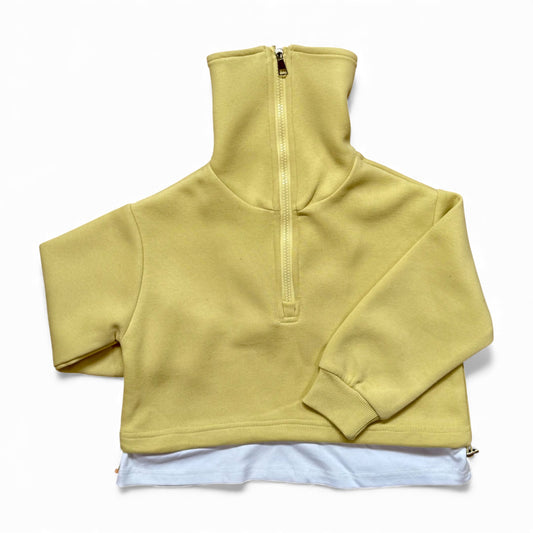 Sherbet-lemon organic cotton children’s tracksuit with funnel-neck top, mock T-shirt underlayer with drawstring, and straight-leg stitched-pleat trousers.