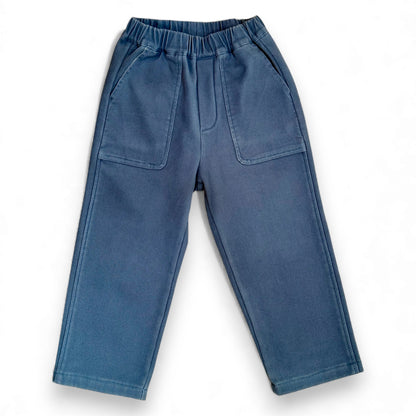 Close-fit blue cotton drill trousers with elasticated waist and front box patch pockets by That’s Not Fair London