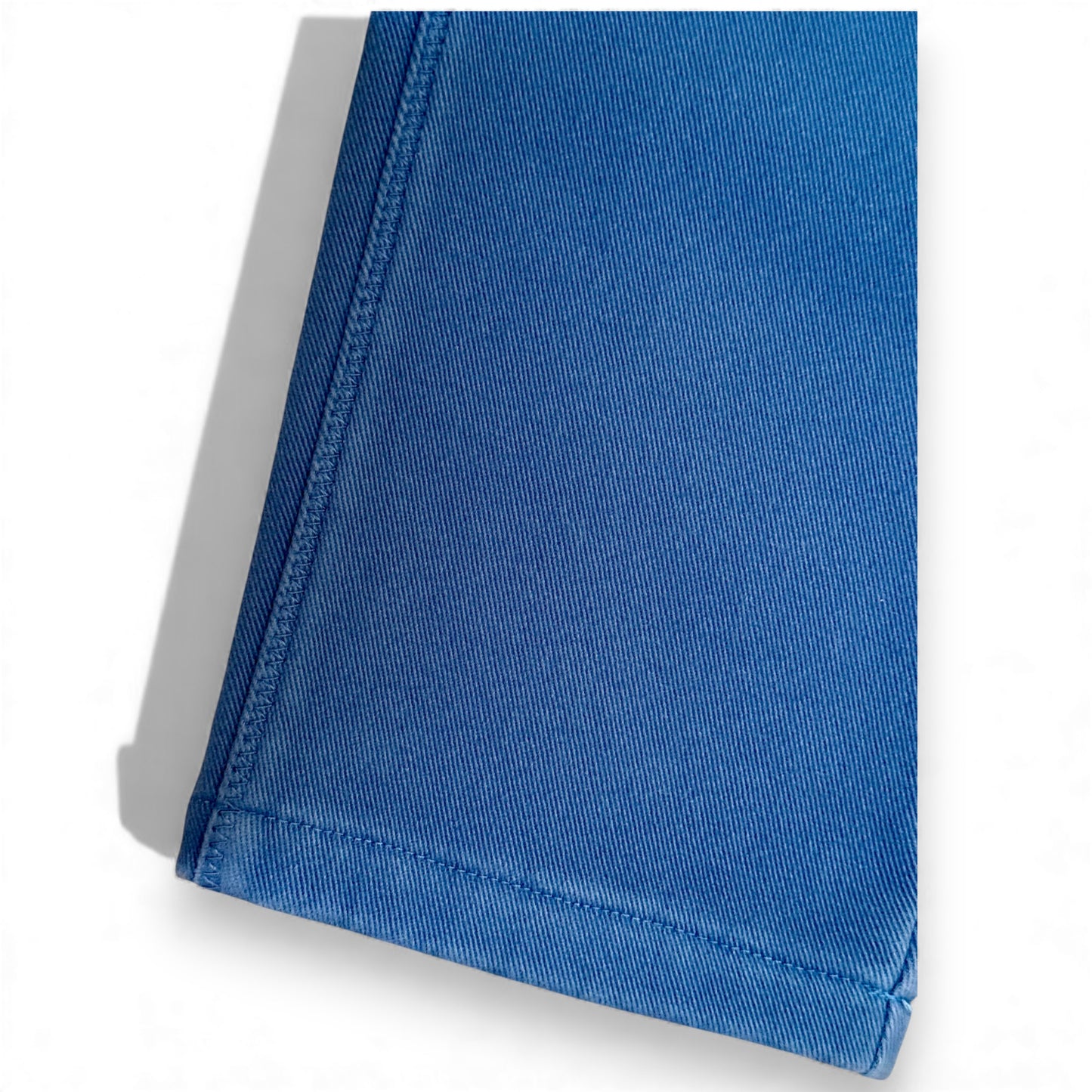 Close-up of blue cotton drill fabric and stitched hem on Nour Pants by That’s Not Fair London