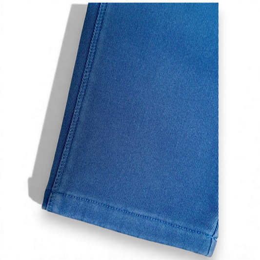Close-up of blue cotton drill fabric and stitched hem on Nour Pants by That’s Not Fair London