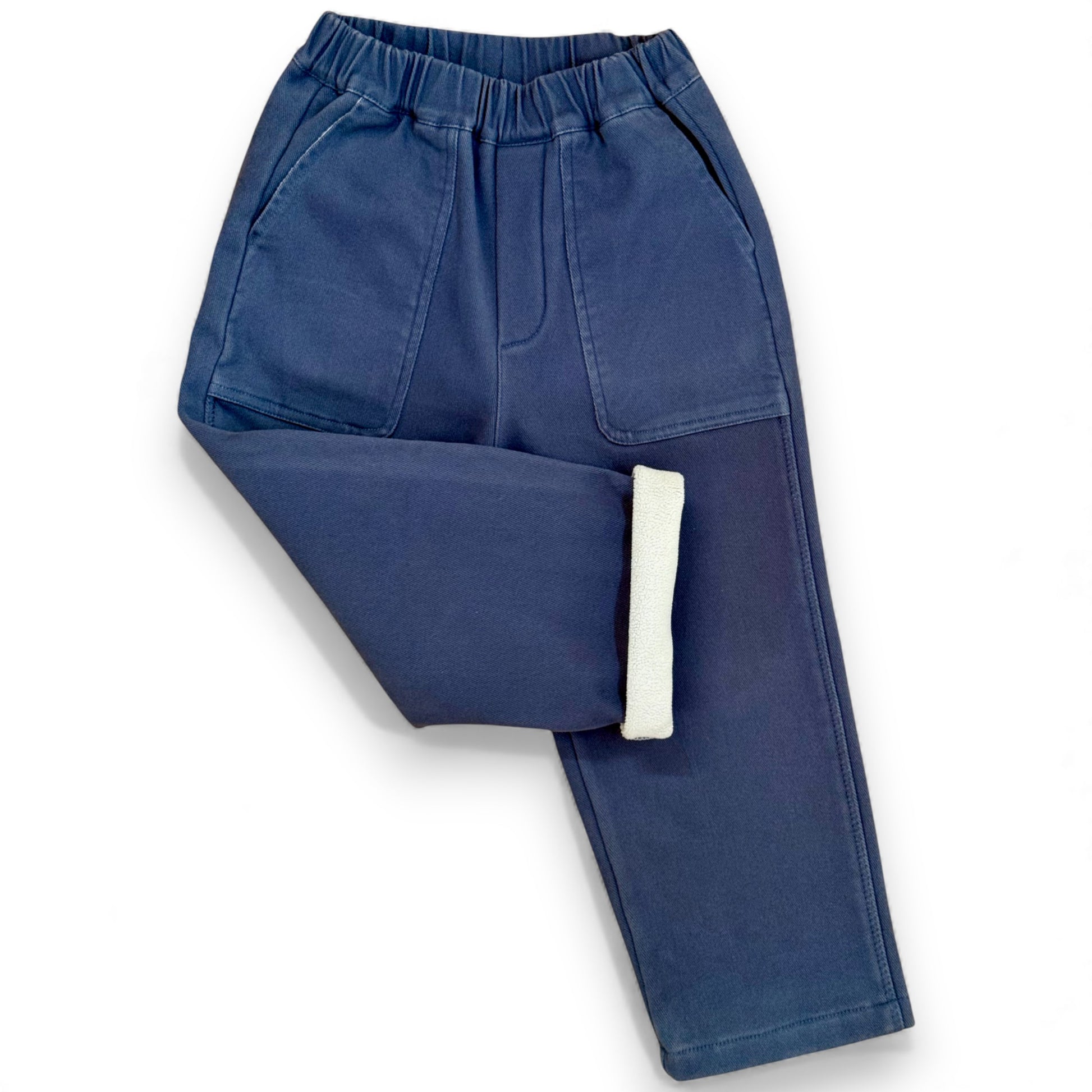 Nour Pants folded to show soft contrast fleece lining inside blue cotton drill trousers