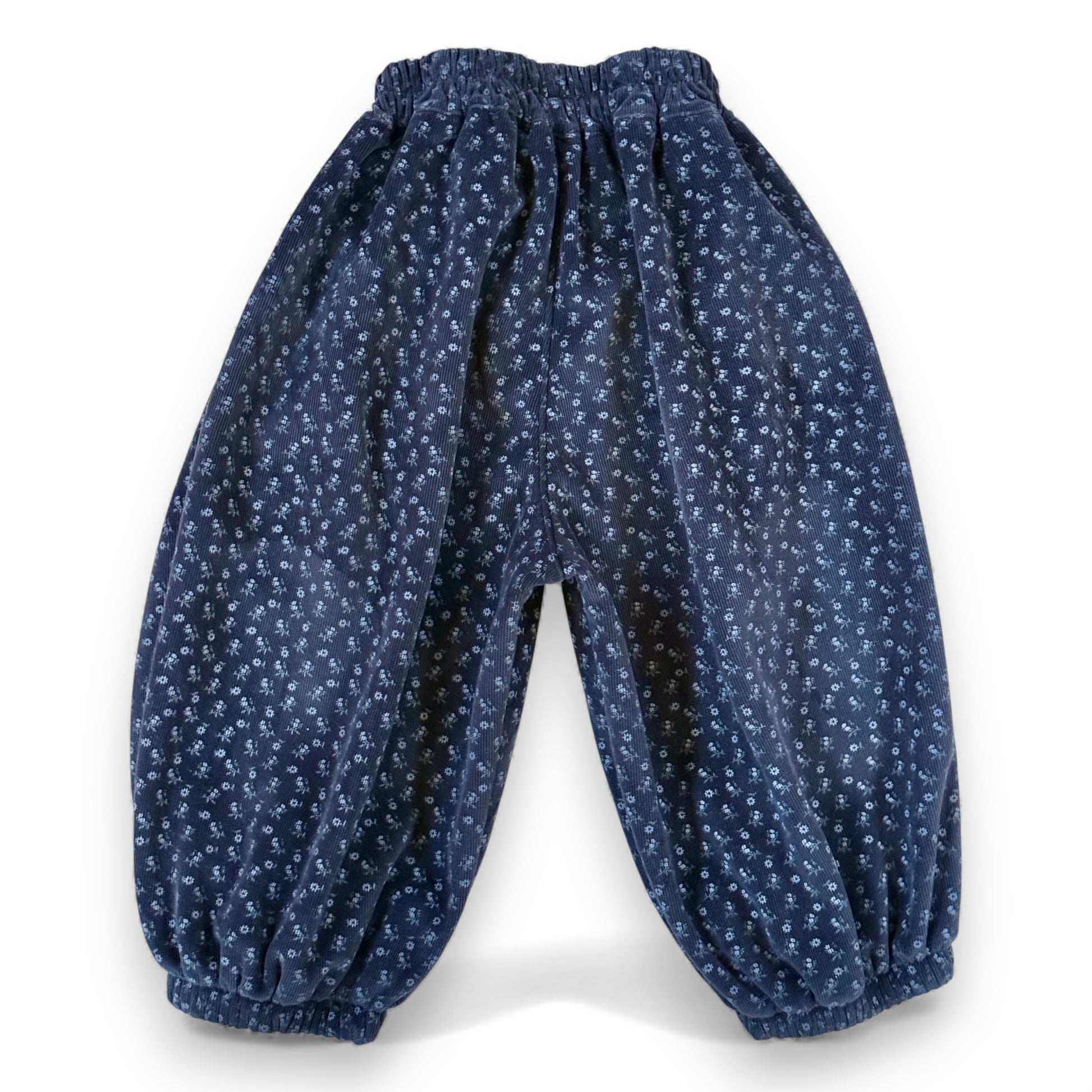 Back view of navy floral needlecord children’s pantaloons with elasticated cuffs and full balloon volume by That’s Not Fair London