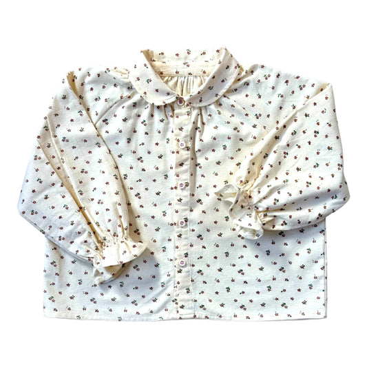 Brushed cotton children’s blouse with slim Peter Pan collar, button front, drop shoulders and frill cuff sleeves.