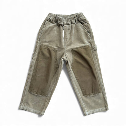 Children’s straight-leg corduroy trousers in sand with contrast knee panels, slant pockets and cargo details — front view.