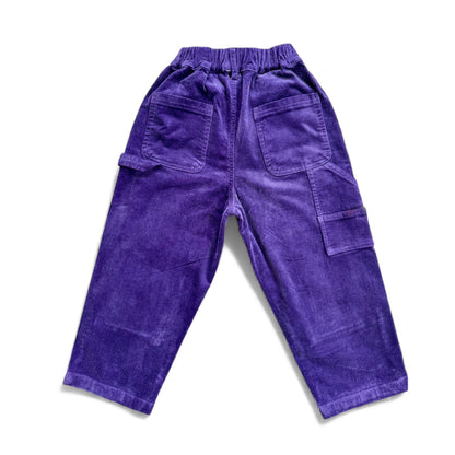Purple corduroy children’s trousers with elasticated waistband, patch pockets and cargo pocket — back view.