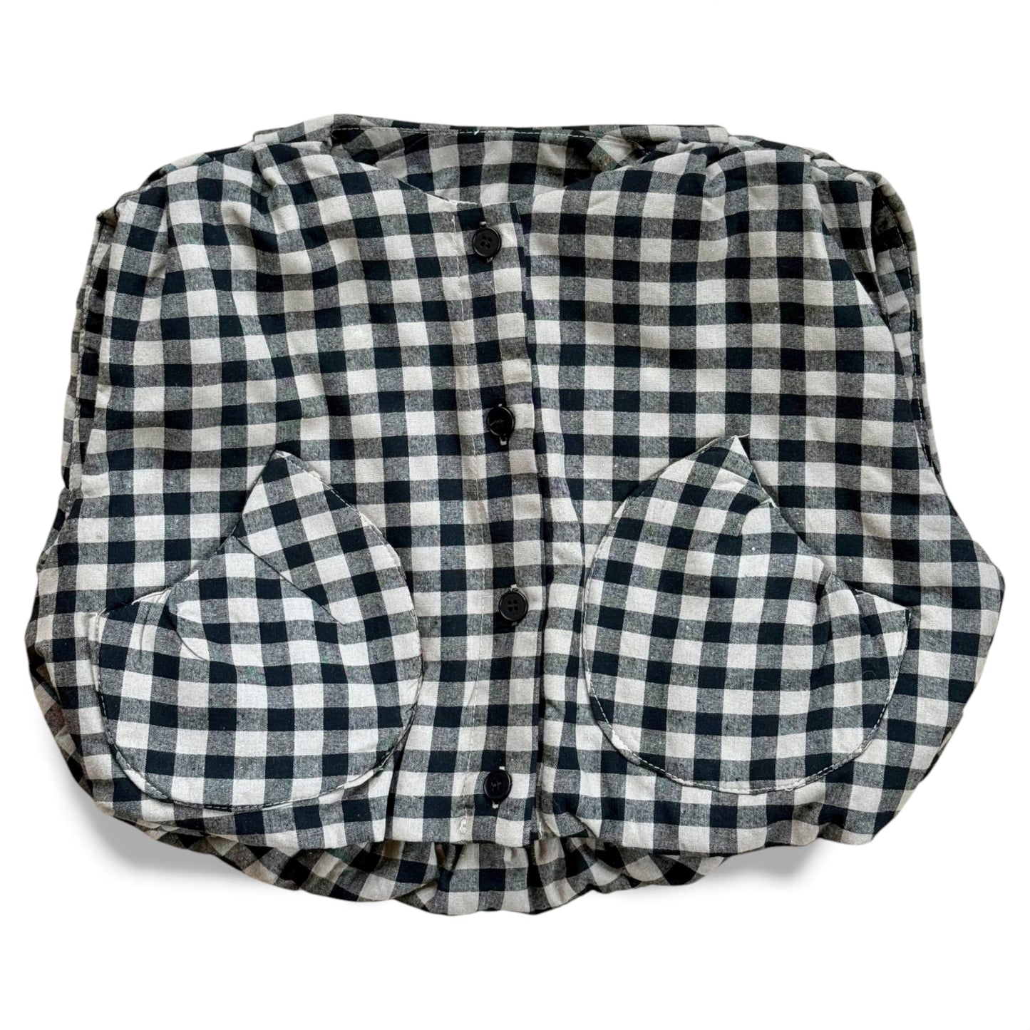 Black-and-cream gingham quilted children’s gilet with petal-shaped pockets and popper fastening.