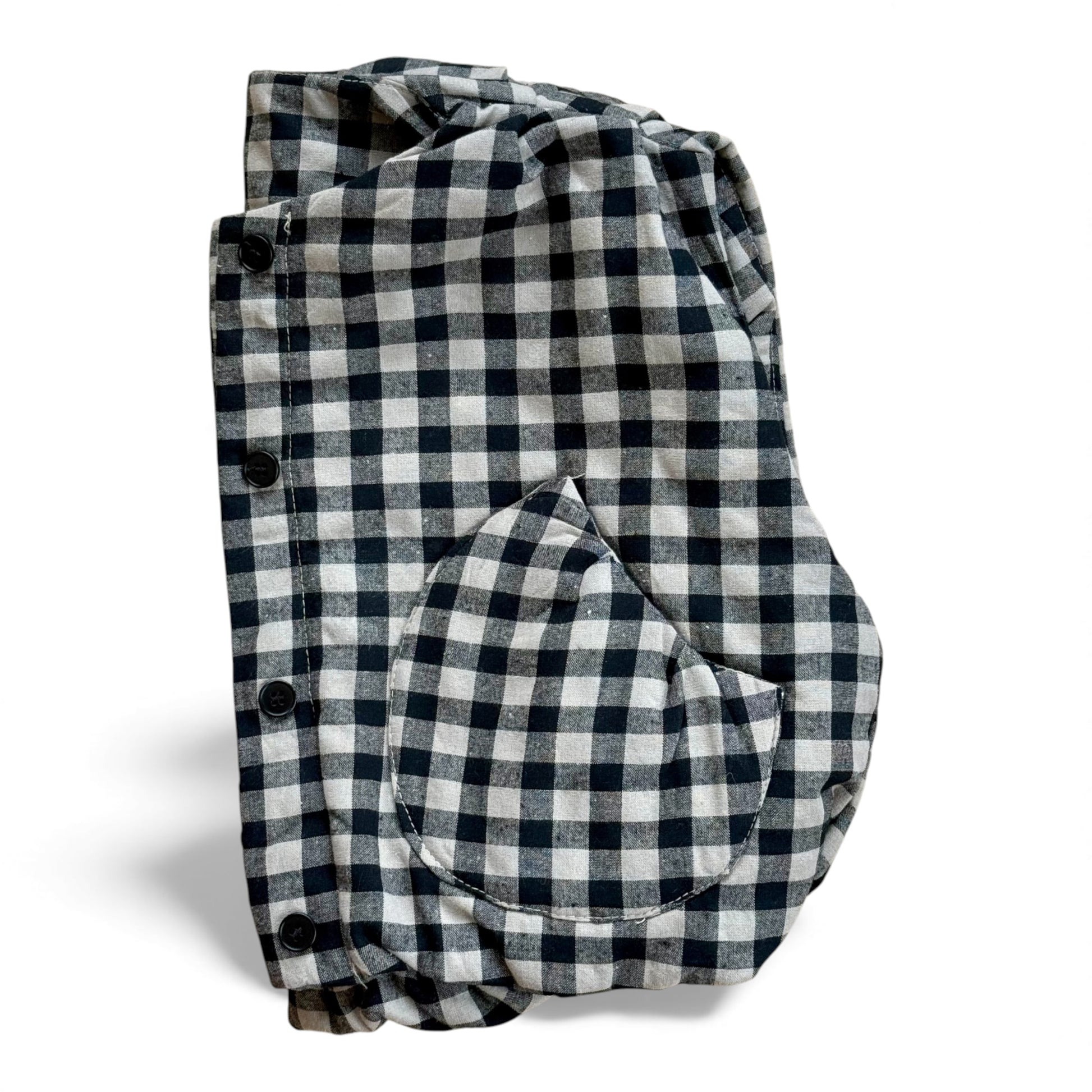 Black-and-cream gingham quilted children’s gilet with petal-shaped pockets and popper fastening.