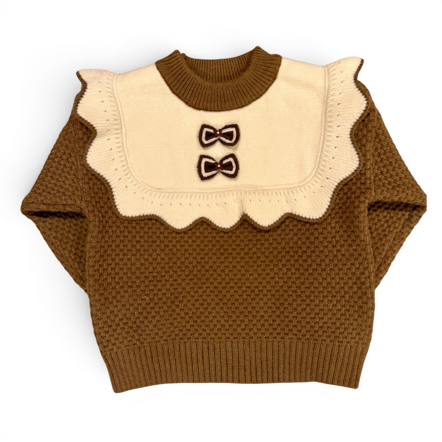 Rummie Jumper in white Victorian-inspired children’s waffle stitch knit with mock bib, frill trim and bow detailing by That’s Not Fair London. Heritage children’s knitwear  