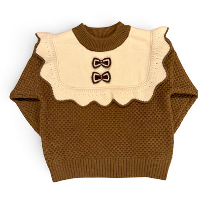 Rummie Jumper in white Victorian-inspired children’s waffle stitch knit with mock bib, frill trim and bow detailing by That’s Not Fair London. Heritage children’s knitwear  