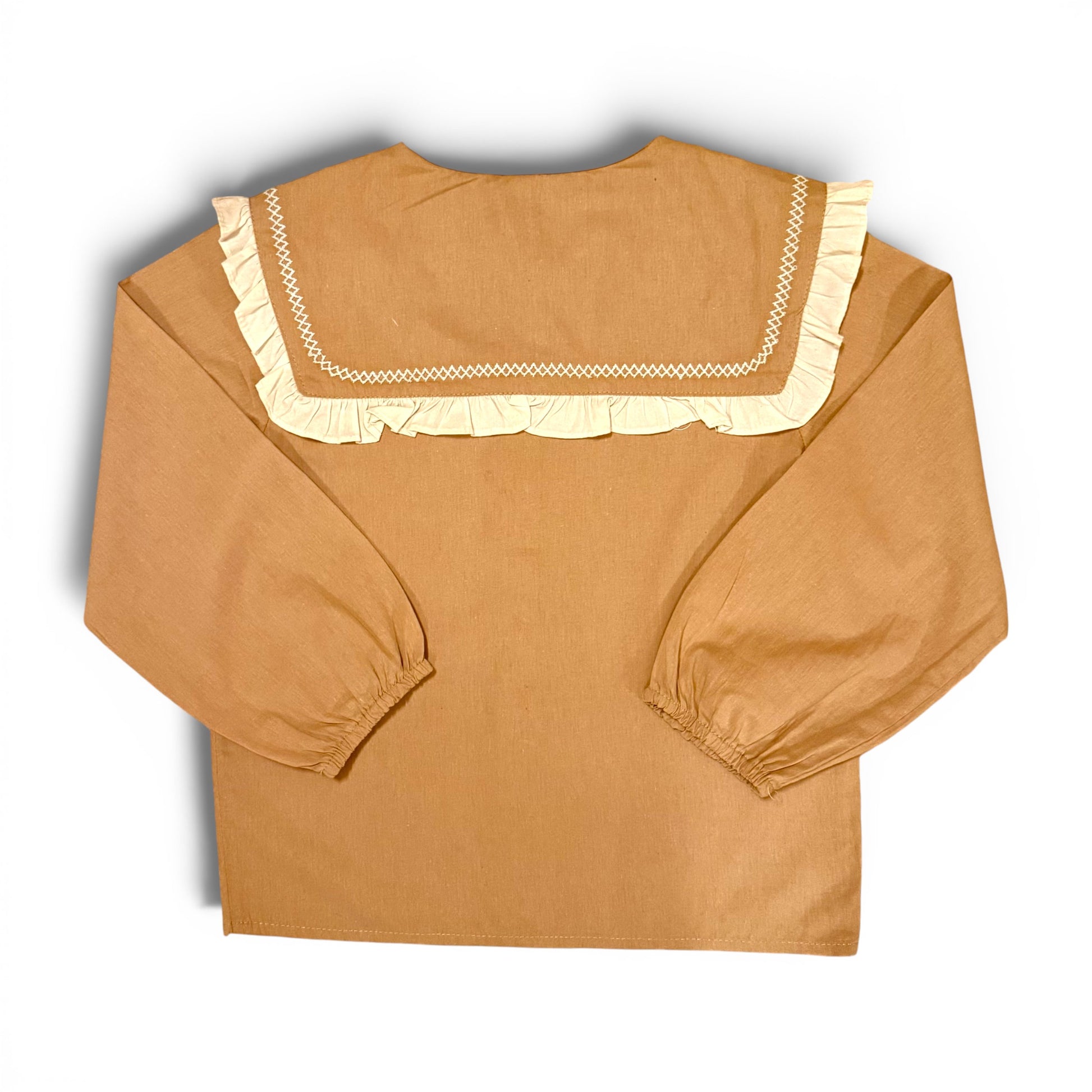 Children’s terracotta organic cotton blouse with oversized sailor collar, embroidered detailing, drop shoulders and cropped wide sleeves.