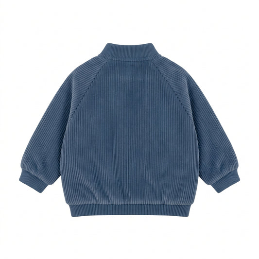 Back view of the Jinny Varsity by That’s Not Fair London, showing the teal blue ribbed velour fabric, raglan sleeves and ribbed collar and hem.