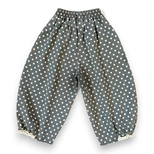 Kehinde Pantaloons in Charcoal Polka Dot – wide-leg cotton denim with lace cuff and elastic waist.