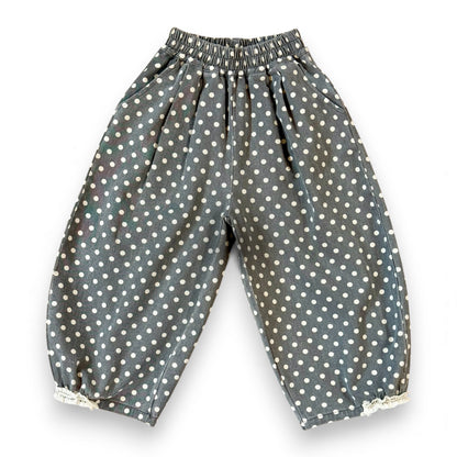 Kehinde Pantaloons in Charcoal Polka Dot – wide-leg cotton denim with lace cuff and elastic waist.