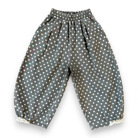 Kehinde Pantaloons in Charcoal Polka Dot – wide-leg cotton denim with lace cuff and elastic waist.