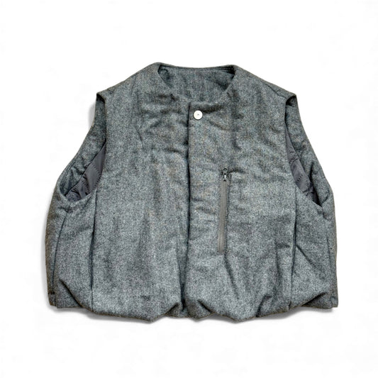 Grey wool children’s gilet with hidden popper placket, swing fit and quilted lining — front view.