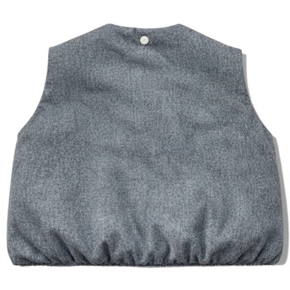 Kids grey wool sleeveless gilet with quilted interior, elastic hem and hidden popper placket. Grey wool children’s gilet cut on the bias for a swing silhouette