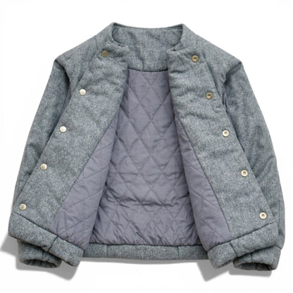 Grey wool kids jacket shown open with quilted lining, snap button placket and elastic hem. Children’s gilet showing diamond-quilted lining and hidden popper fastening 