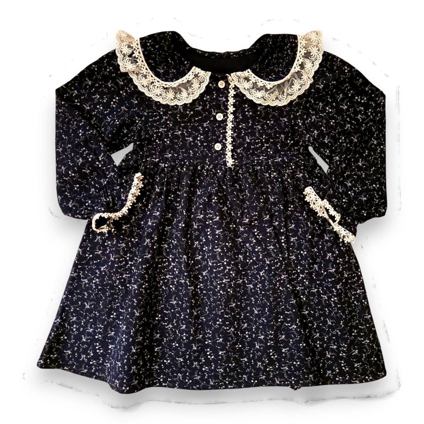 Lelija dress by That’s Not Fair London, navy brushed cotton baby dress with floral print, Peter Pan collar with lace trim, empire line silhouette and front button fastening
