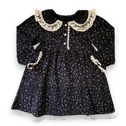 Lelija dress by That’s Not Fair London, navy brushed cotton baby dress with floral print, Peter Pan collar with lace trim, empire line silhouette and front button fastening