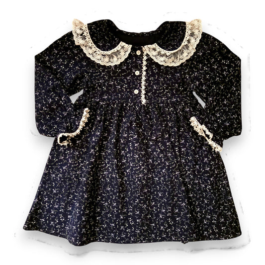 Lelija dress by That’s Not Fair London, navy brushed cotton baby dress with floral print, Peter Pan collar with lace trim, empire line silhouette and front button fastening