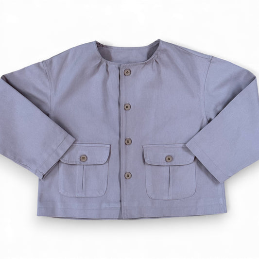 Powder pink children’s cotton jacket with crew neck, button fastening, front patch pockets and drop shoulders, laid flat