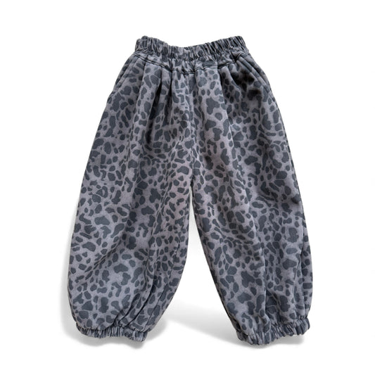 Animal-print children’s pantaloons with high gathered waist, front inverted pleats, scoop pockets and elasticated cuffs — front view.