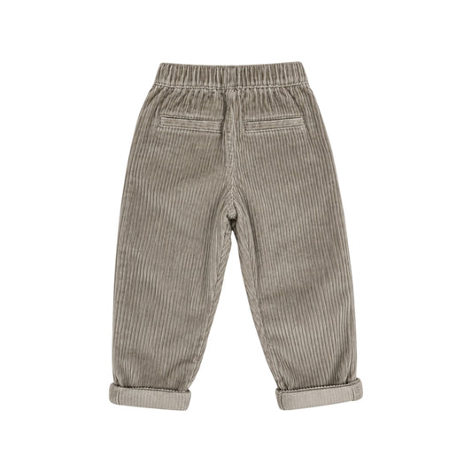 Back view of the Pople Pants by That’s Not Fair London, showing taupe ribbed velour fabric, an elasticated waistband and two welt pockets.

