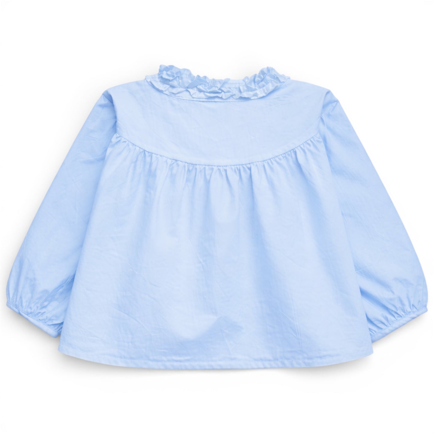 Back view of pale sky blue trapeze cotton blouse with gathered yoke and ruched balloon sleeves, That’s Not Fair London